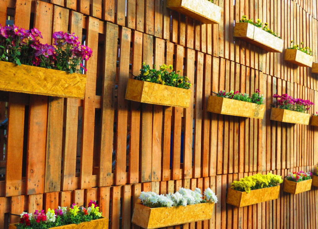 The Benefits of Adding Hanging Planters to Your Fence